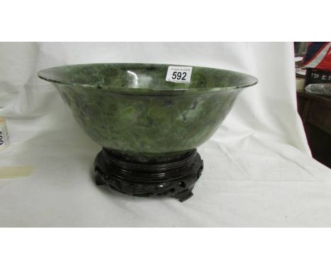 A large jade bowl on stand, 23 cm diameter.*CONDITION REPORT*In good condition with no chips or cracks observed