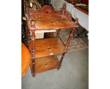 A Victorian mahogany inlaid three shelf stand.  Collect only.  