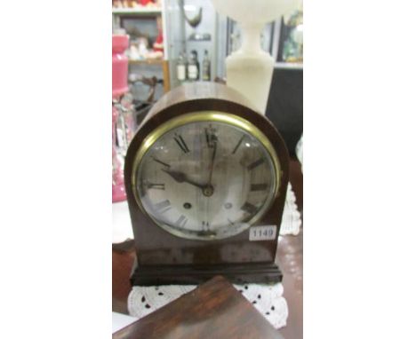 A mahogany mantel clock in good condition.  
