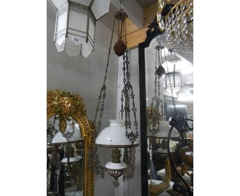 A late Victorian adjustable hanging oil lamp with drop in glass font and original shade. Collect only.*condition report*Surfa