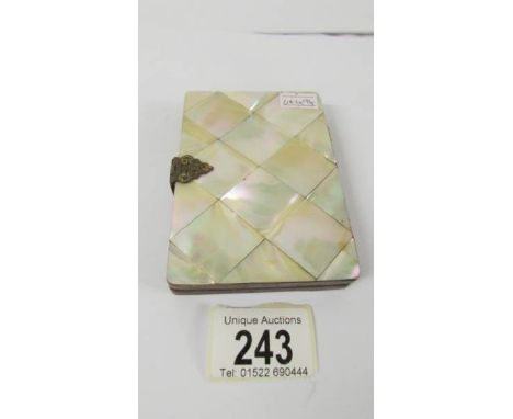 A mother of pearl on wood envelope card case.  