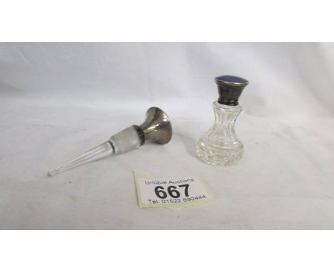 A glass perfume bottle with silver enamelled top and a decanter stopper with silver and enamel top.  