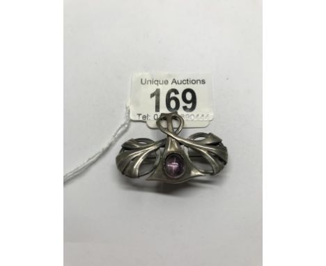 An Art nouveau white metal and amethyst brooch, boxed.  No visible makers marks, in good condition, 4.5cm x 3.5cm
