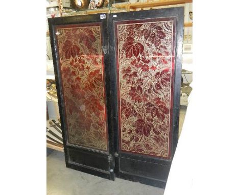 A pair of wood framed ruby overlaid glass doors.  