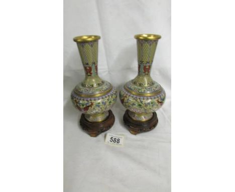 A pair of decorative Cloissonne vases on bases, vases 18cm tall, with bases 21.5cm tall.*condition report*1 has a slightly mi