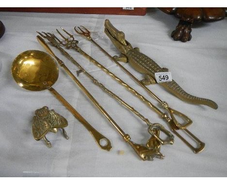 A collection of mainly 19th century novelty brass items, including an  engraved figural vesta holder