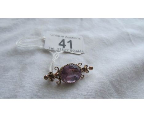 A vintage brooch set large amethyst, tests as gold.  
