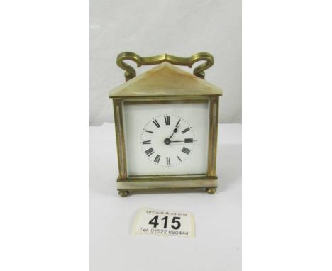 A small brass and onyx mantel clock.