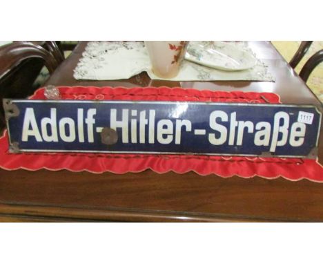 An old enamel street sign - Adolf-Hitler-Strabe/Street *condition report*80cm x 14cm, rust spot under 'H' caused by bullet. C
