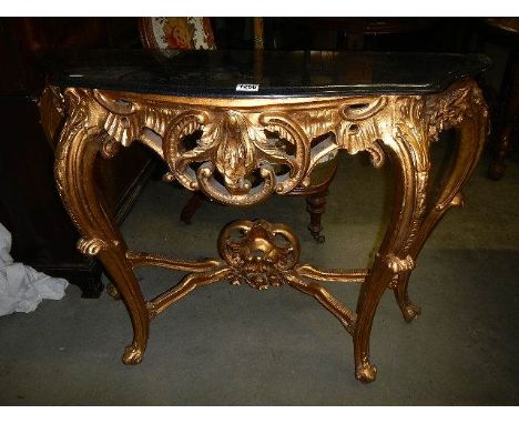 A gilded console table with marble top.  