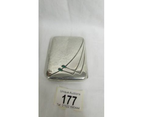A silver cigarette case, gem set, with blue enamelled monogram and inscribed message on reverse. "W. Chilton, a  small souven
