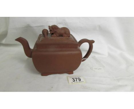 A Chinese earthenware teapot with dog of foo knob to lid. A/F  