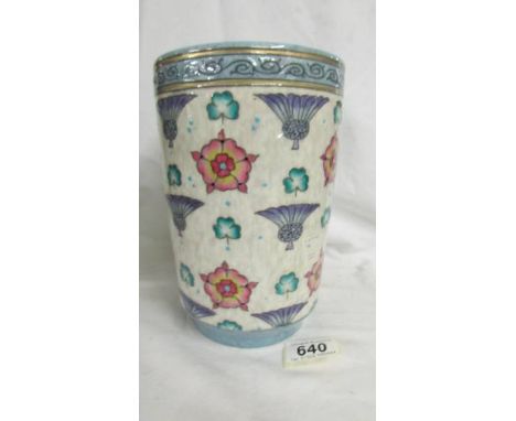 A wide Bursley ware vase by Charlotte Rhead. White dapple ground with blue thistles, red roses and green three leaf clovers. 