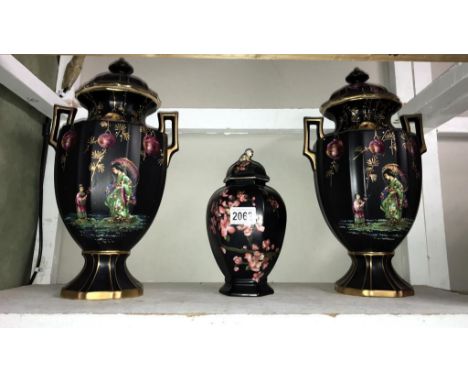 A pair of 19th century Olympic lidded urns with oriental decoration. (height 39cm) &amp; Carltonware urn with chip to lid (he