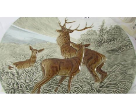 A large ceramic charger depicting stag and deer marked Schutz Blansko (rim chips). Collect only.  