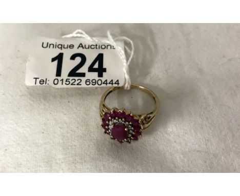 A yellow gold ruby and diamond ring, size P.  