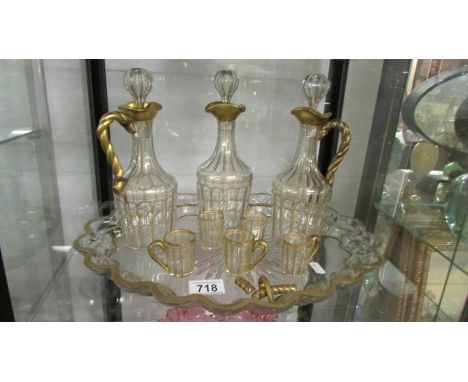 A three bottle decanter set on tray, a/f. Collect only.*CONDITION REPORT*Bottle height 23cm.Tray 32cm x 39.5cm.