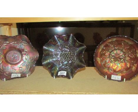 Three carnival glass bowls including Fenton amethyst autumn acorns, Fenton marigold holly and one other.  