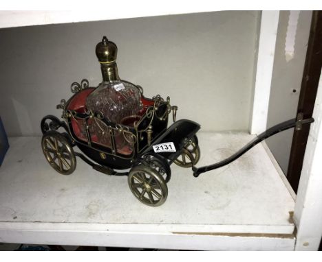A 1950's musical decanter stand in the form of a carriage complete with decanter &amp; 4 glasses  