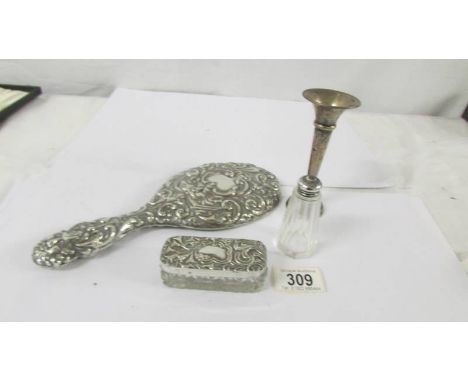 A silver backed hand mirror, a silver topped trinket pot, a silver spill vase and a silver topper bottle.  