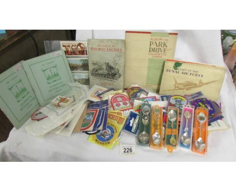 A good selection of tourist souvenir cloth patch badge and a quantity of cigarette card albums.  