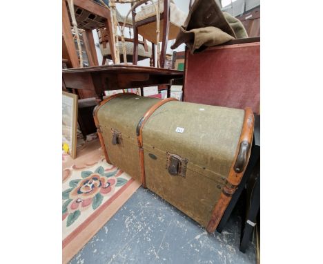 A KHAKI CANVAS COVERED TRUNK