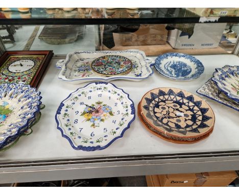 A COLLECTION OF SPANISH ALBALAT POTTERY DISHES TOGETHER WITH TWO CLOCKS WITH CERAMIC FACES