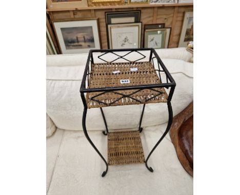 AN IRON TABLE WITH TWO CANED TIERS TOGETHER WITH A MESH FIRESCREEN