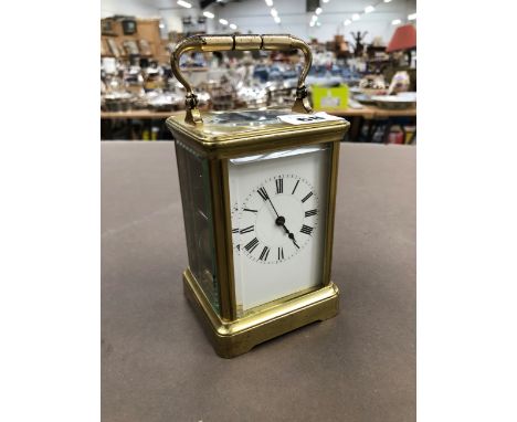 A VINTAGE FRENCH CARRIAGE CLOCK STRIKING ON A COILED ROD.