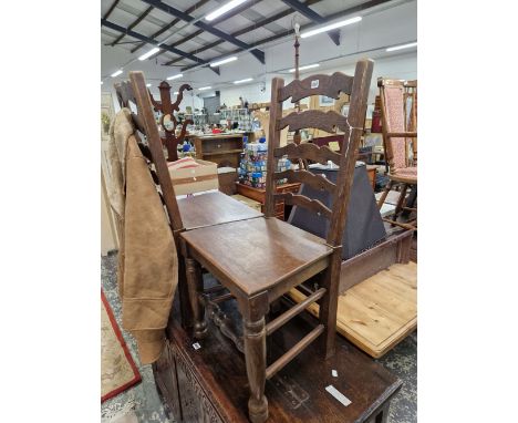 A PAIR OF OAK LADDER BACK CHAIRS WITH SOLID SEATS