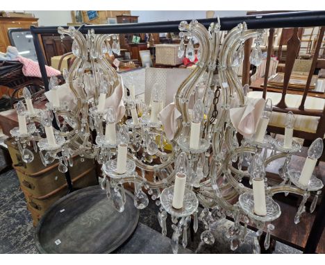 A PAIR OF SIXTEEN LIGHT CHANDELIERS MOUNTED IN GLASS AND HUNG WITH DROPS