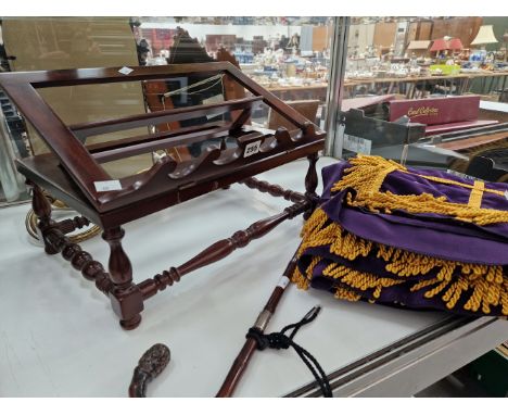 A MAHOGANY DESK TOP LECTERN, A WALL LIGHT, A WALKING STICK AND A YELLOW TASSELLED PURPLE VELVET PANEL