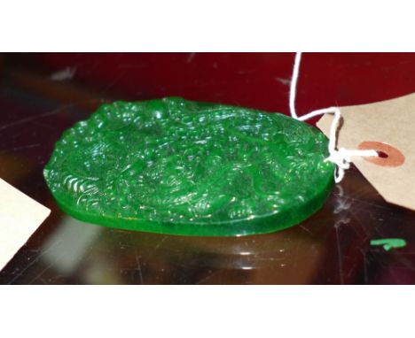A Chinese jade pendent with mythical beasts in relief