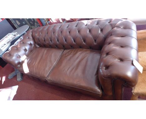 A Chesterfield sofa upholstered in buttoned brown leather with studded detail 