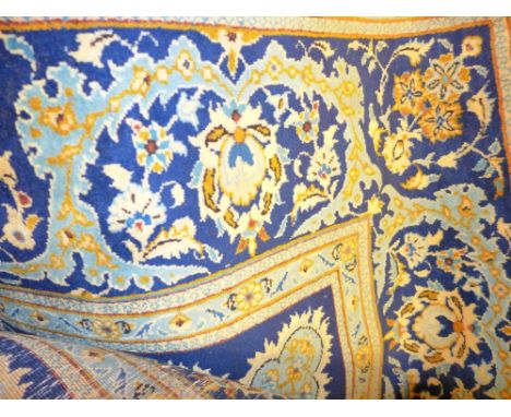 An extremely fine central Persian Qum carpet 340cm x 235cm, central ivory floral medallion on a sapphire field within stylise