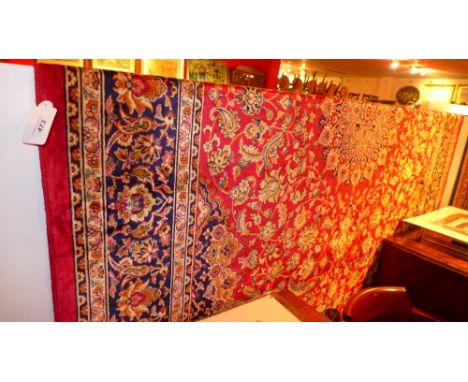 A Keshan style carpet with palmettes on a red field surrounded by one frieze and two running borders 280 x 200cm 