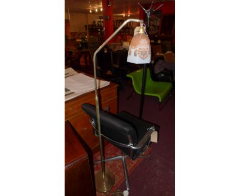 An early 20th century brass floor standing lamp with frosted glass shade