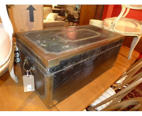 An Antique leather clad travel trunk with brass studded detail and fittings 