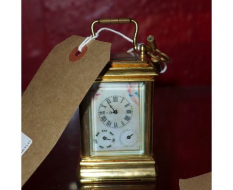 A brass miniature carriage clock with Sevres style panels and three dials 