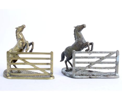 A pair of equestrian brass book ends cast as horses leaping a gate, on shaped rocky ground base, 20th centuiry, 28 cm wide 