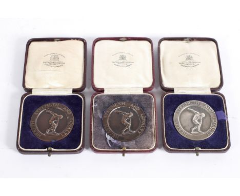 A 1920's 'Health, Strength and Loyalty' silver medal, dated 1927; together with two bronze examples, all boxed, silver weight