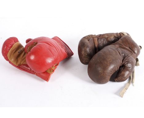 Two pairs of vintage leather boxing gloves including a brown leather pair bearing a label for Sykes and a red leather pair st