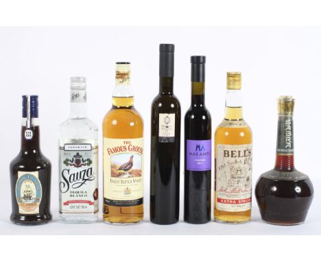 Eight bottles of alcohol, including early Bell's Old Scotch Whisky, Extra Special 70 proof, Sauza Tequila and others