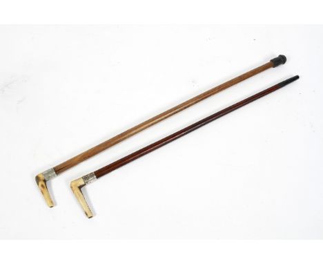 Two silver collared malacca swagger sticks with horn handles,  circa 1900, one by Swain &amp; Co with foliate engraved collar