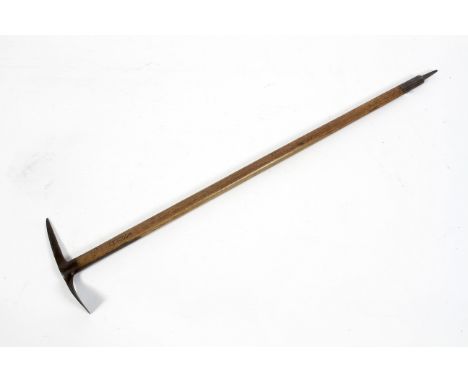 An early 20th century ice pick axe, with serrated steel blade, the turned wooden handle later incised 'Woodley', 110.5 cm lon