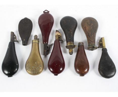 A collection of nine assorted gun powder flasks, including leather examples and a and brass example cast with a hunting scene
