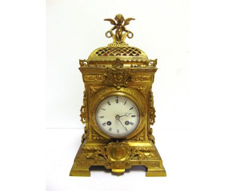 A FRENCH GILT-BRASS MANTEL CLOCK  late 19th century, the 9cm diameter circular white enamel dial with black Roman numerals, f