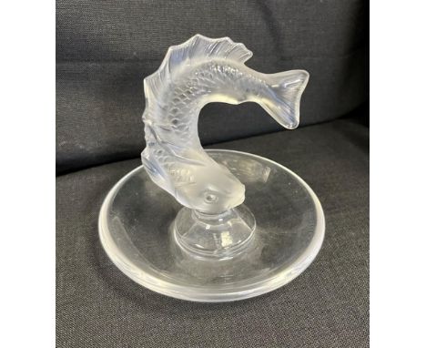 A LALIQUE GLASS TRINKET DISH  centred with a turning fish, the base engraved 'Lalique / France', 9cm high. Condition Report :