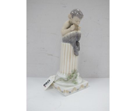 Royal Copenhagen Figure of Faun Playing Pipes Atop a Fluted Pedestal, Model No 433, 21cm high.