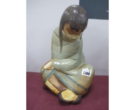 A Lladro Matte Porcelain Figure of an Eskimo Girl, seated cross legged, printed and impressed marks, 29.5cm high.
